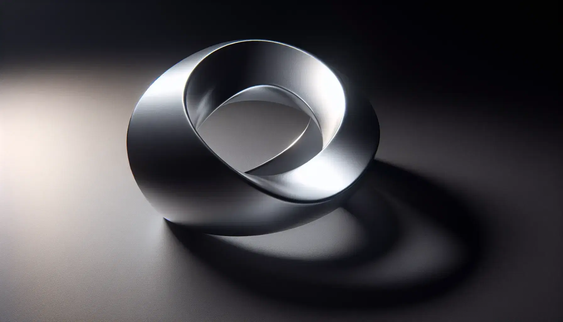 Smooth metallic Möbius strip with half-twist on dark matte surface, soft reflections highlight the three-dimensional shape.
